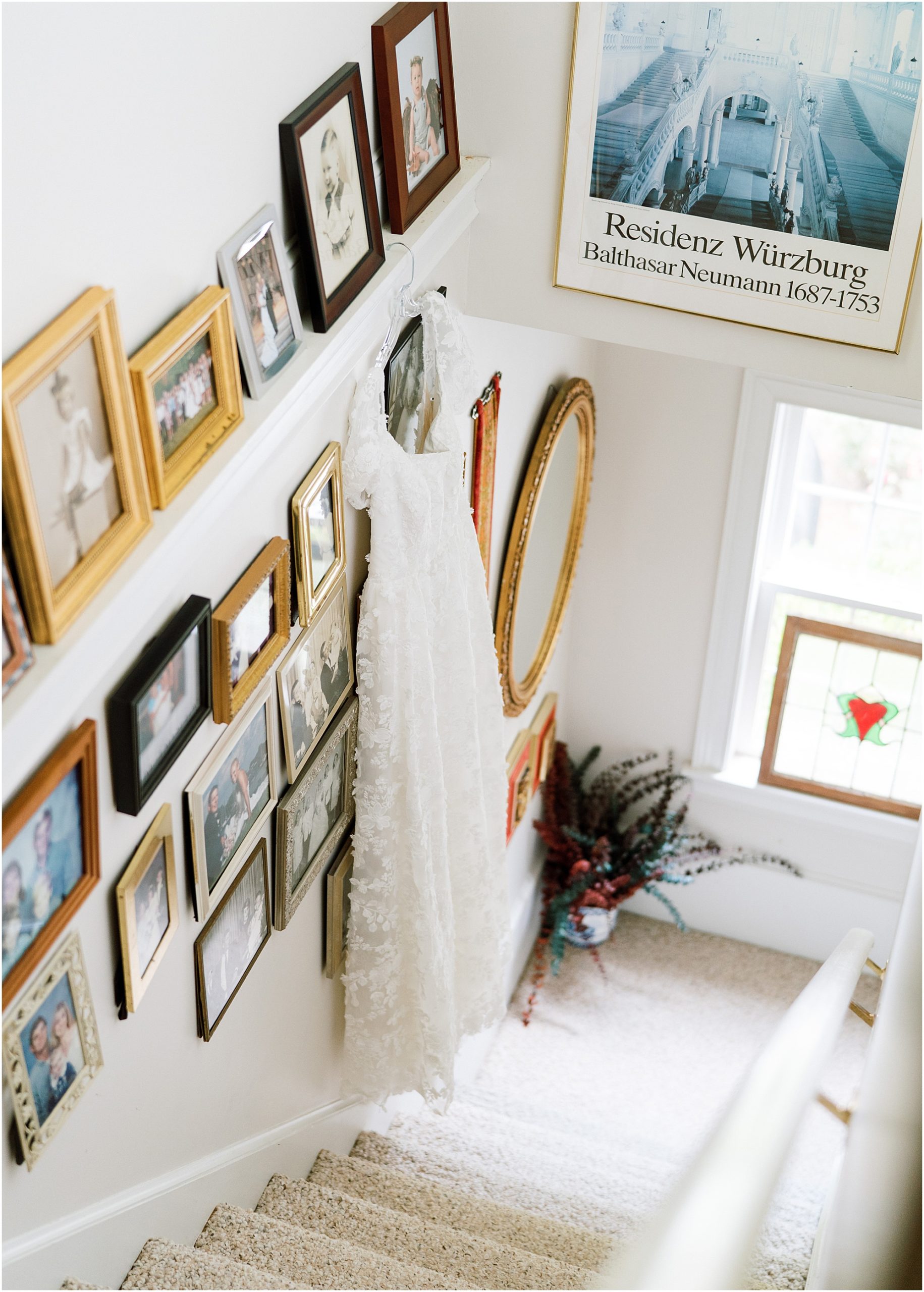 brides dress hanging on family wedding gallery wall