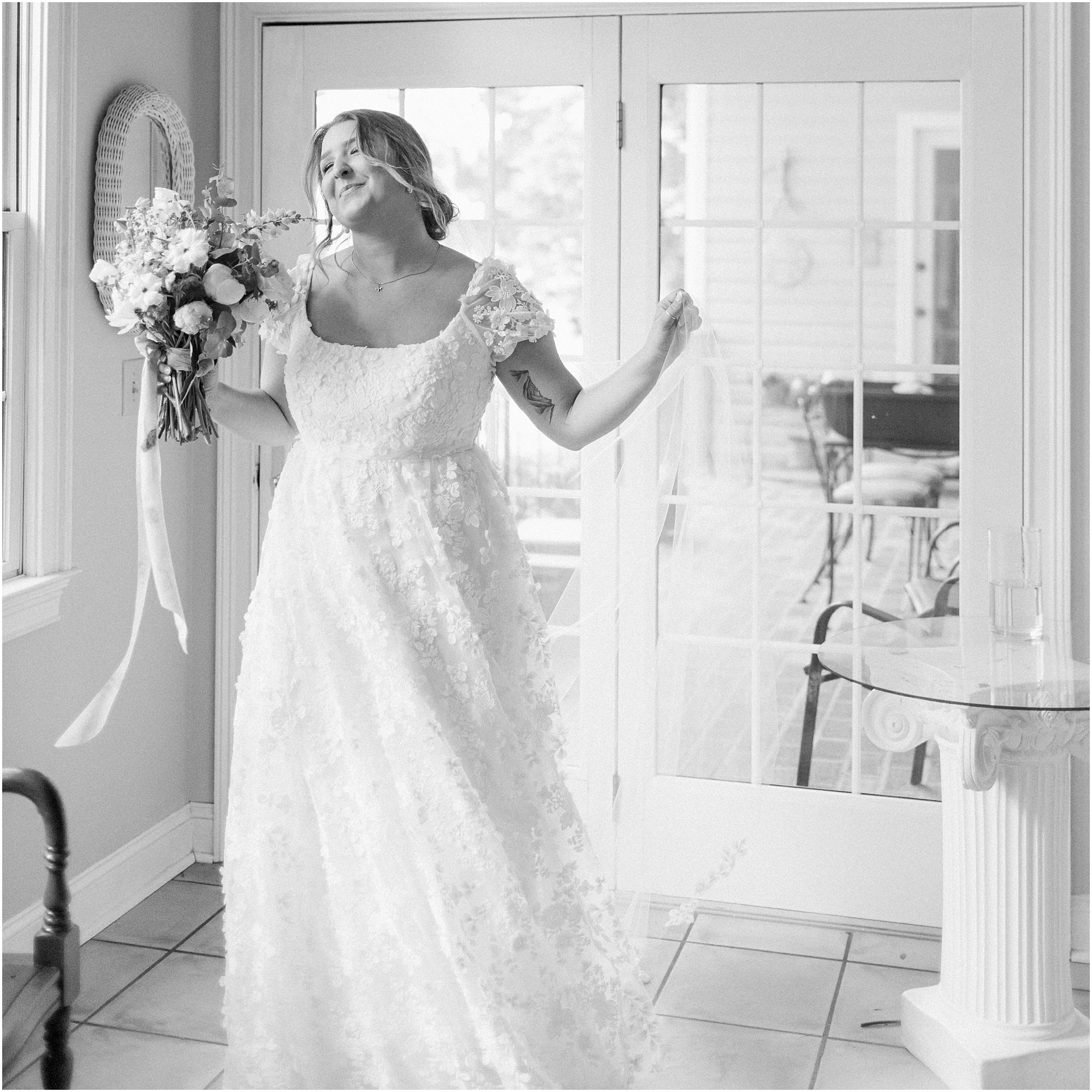Bride laughing and spinning around in her wedding dress. Black and white photo of bride dancing in her wedding dress.