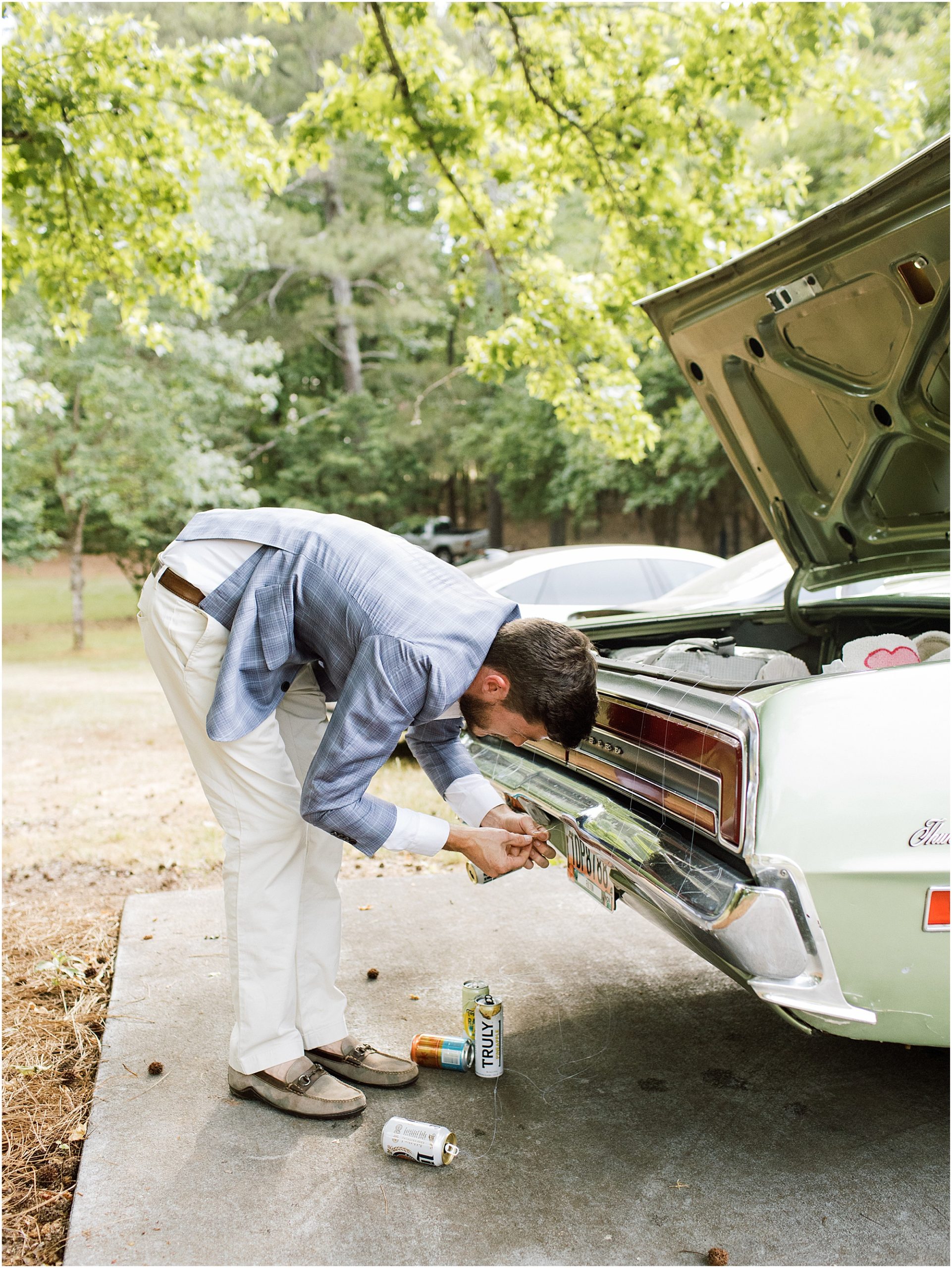 Wedding guest ties cans to back of the getaway car.