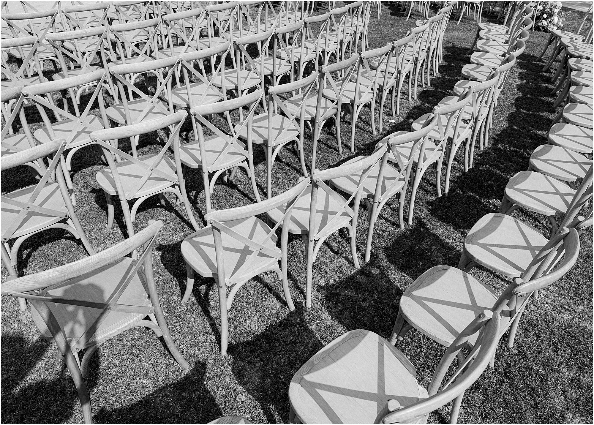 black and white photo of wedding ceremony chairs