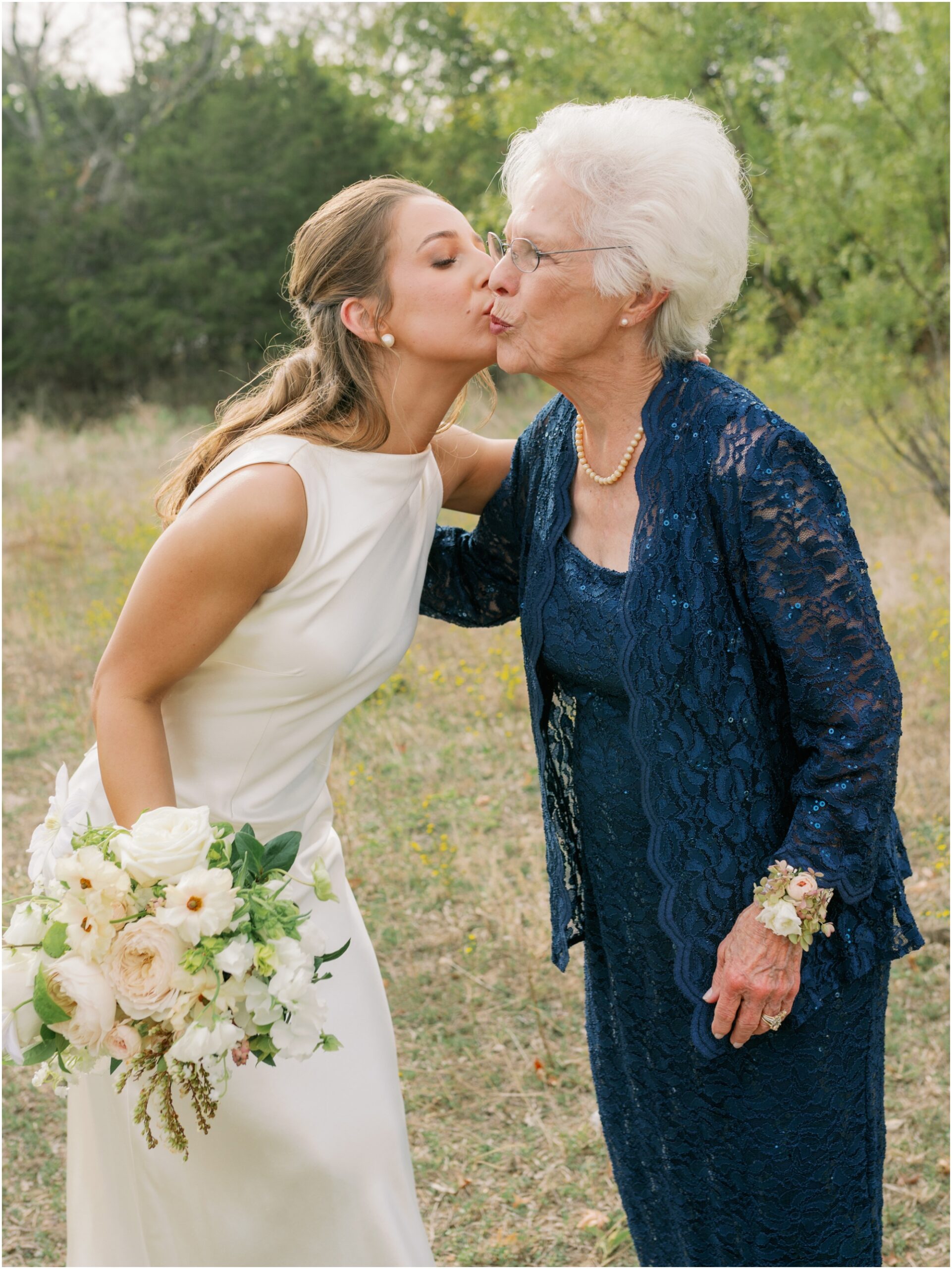 bride and grandma hugging on wedding day