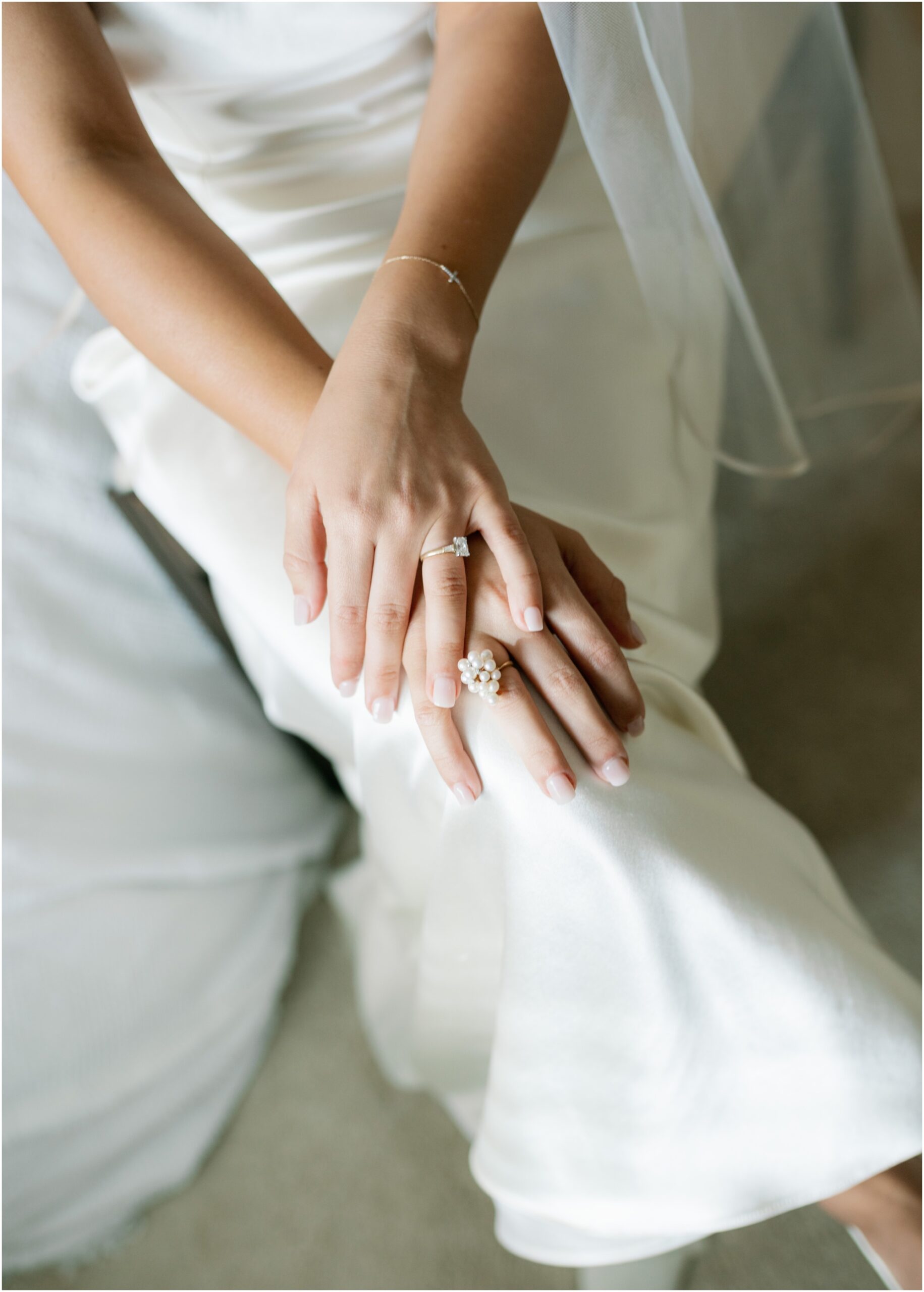 brides rings on her lap in danielle frankel dress from an elevated backyard wedding in fort worth, Texas