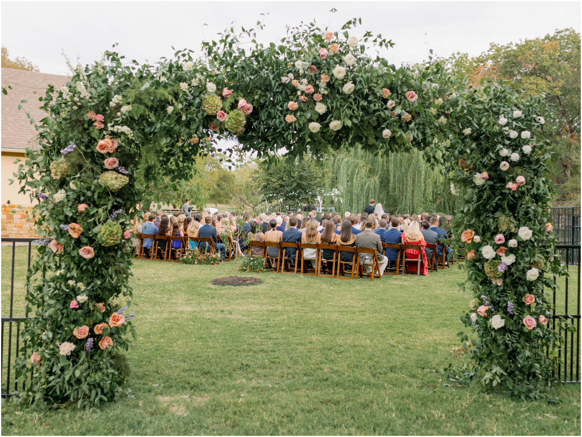 large green arch from wedding ceremony from an elevated backyard wedding in fort worth, Texas