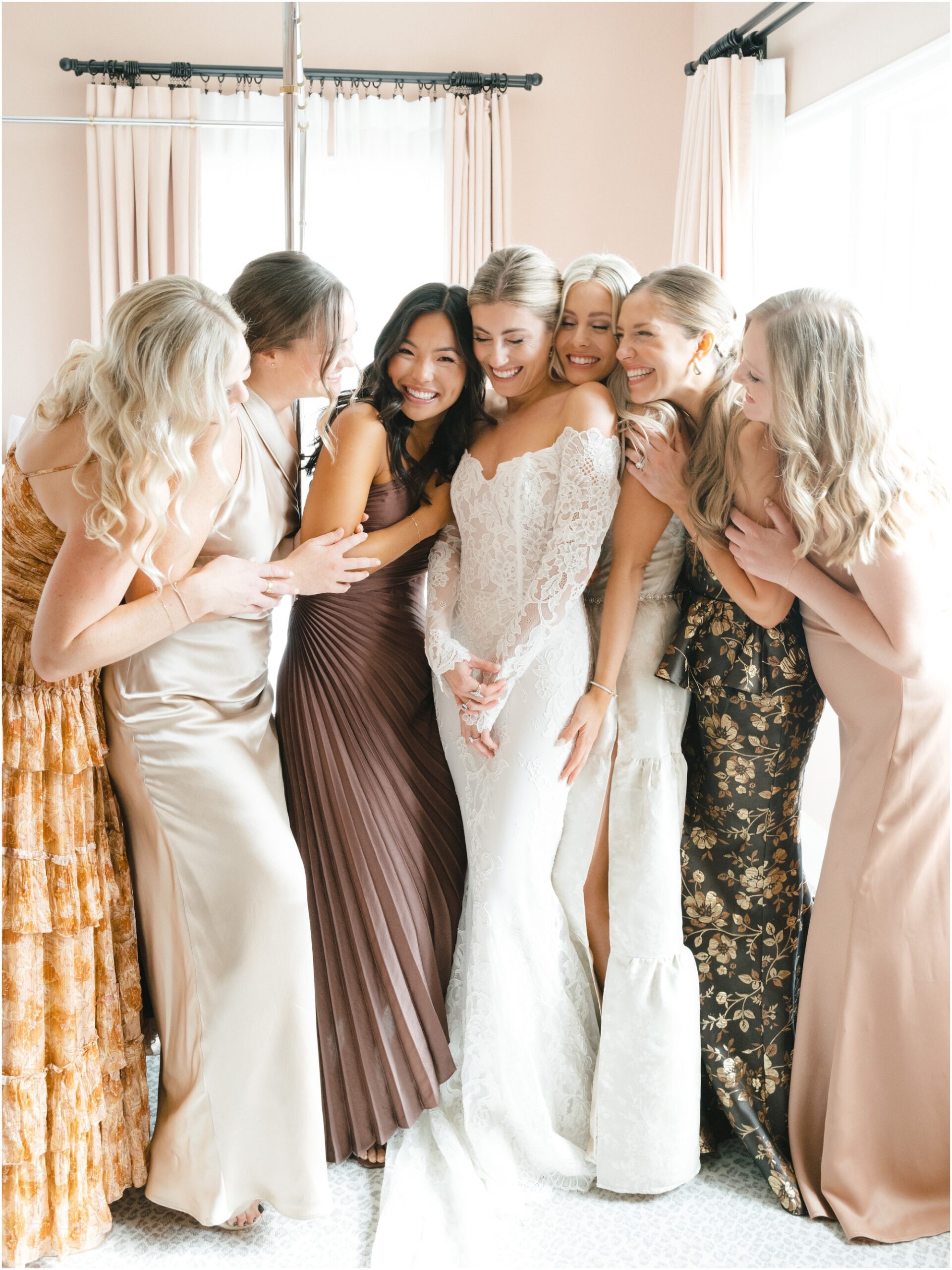 bride does first look with bridesmaids at commodore perry estate in austin texas while bridesmaids wear different dresses
