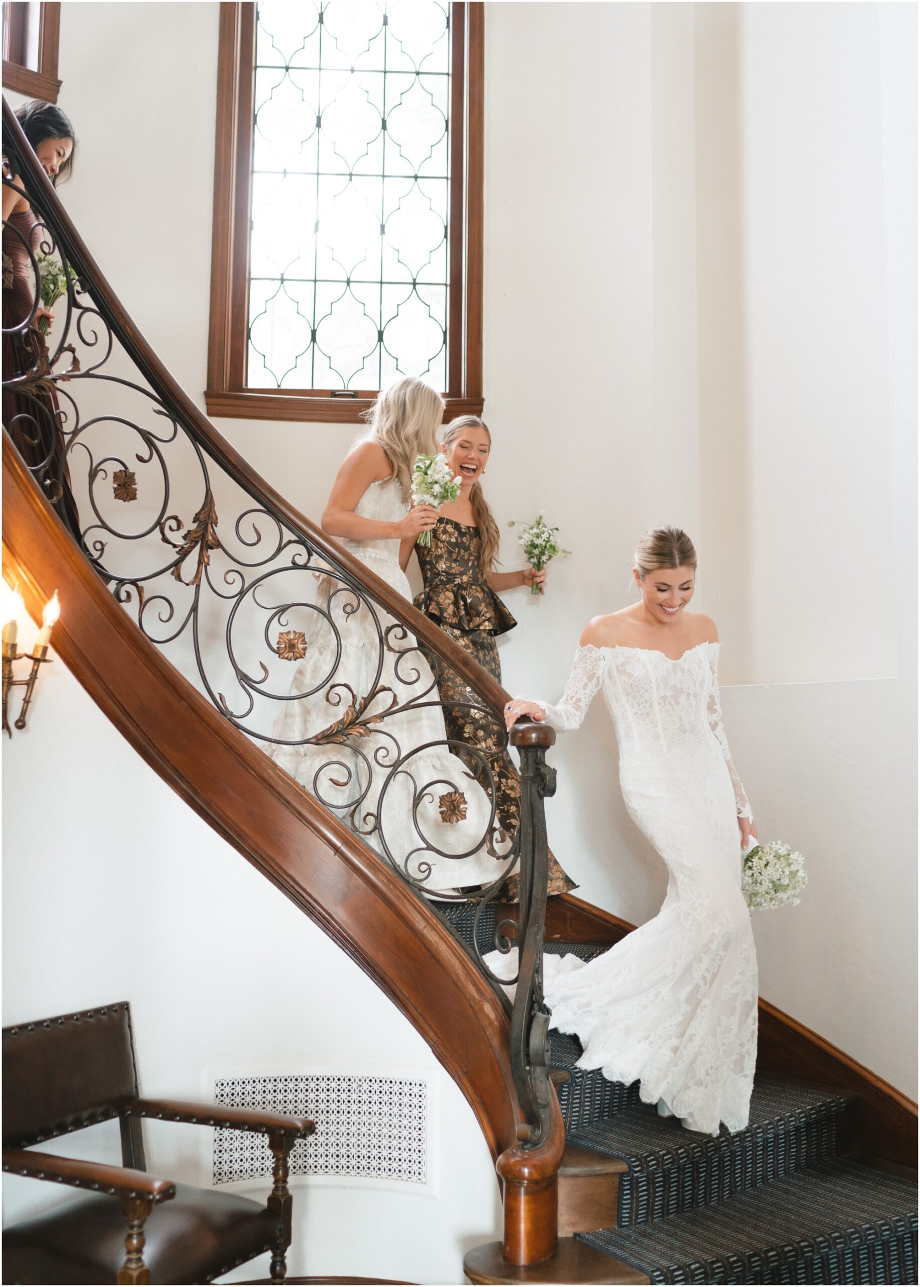 bride and bridesmaids walking downstairs at commodore perry estate in austin texas