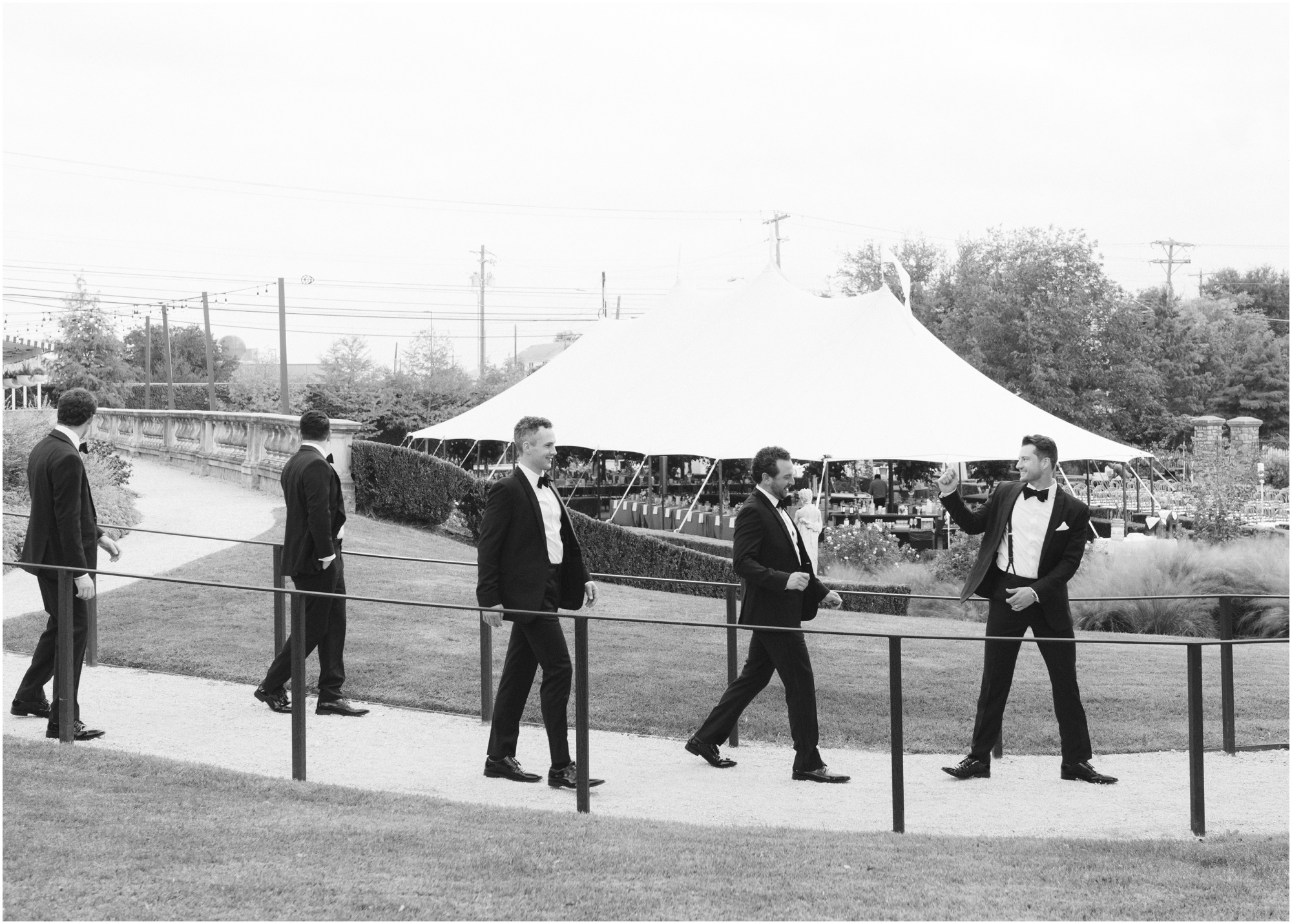 groomsmen walking around venue at a wedding at commodore perry estate in austin texas