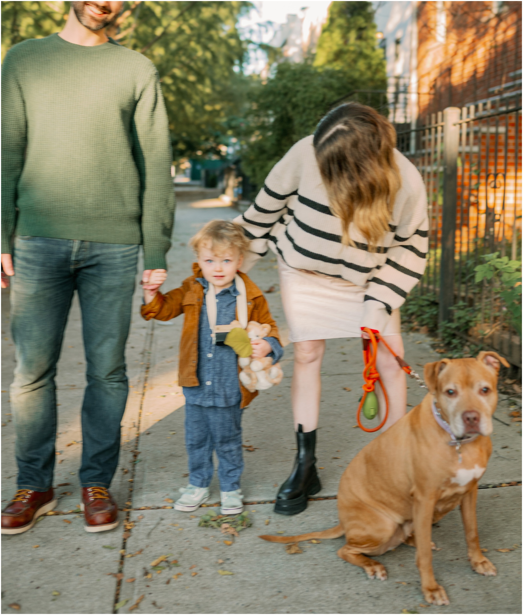 family portrait of three with dog on the sidewalk in Brooklyn, New York