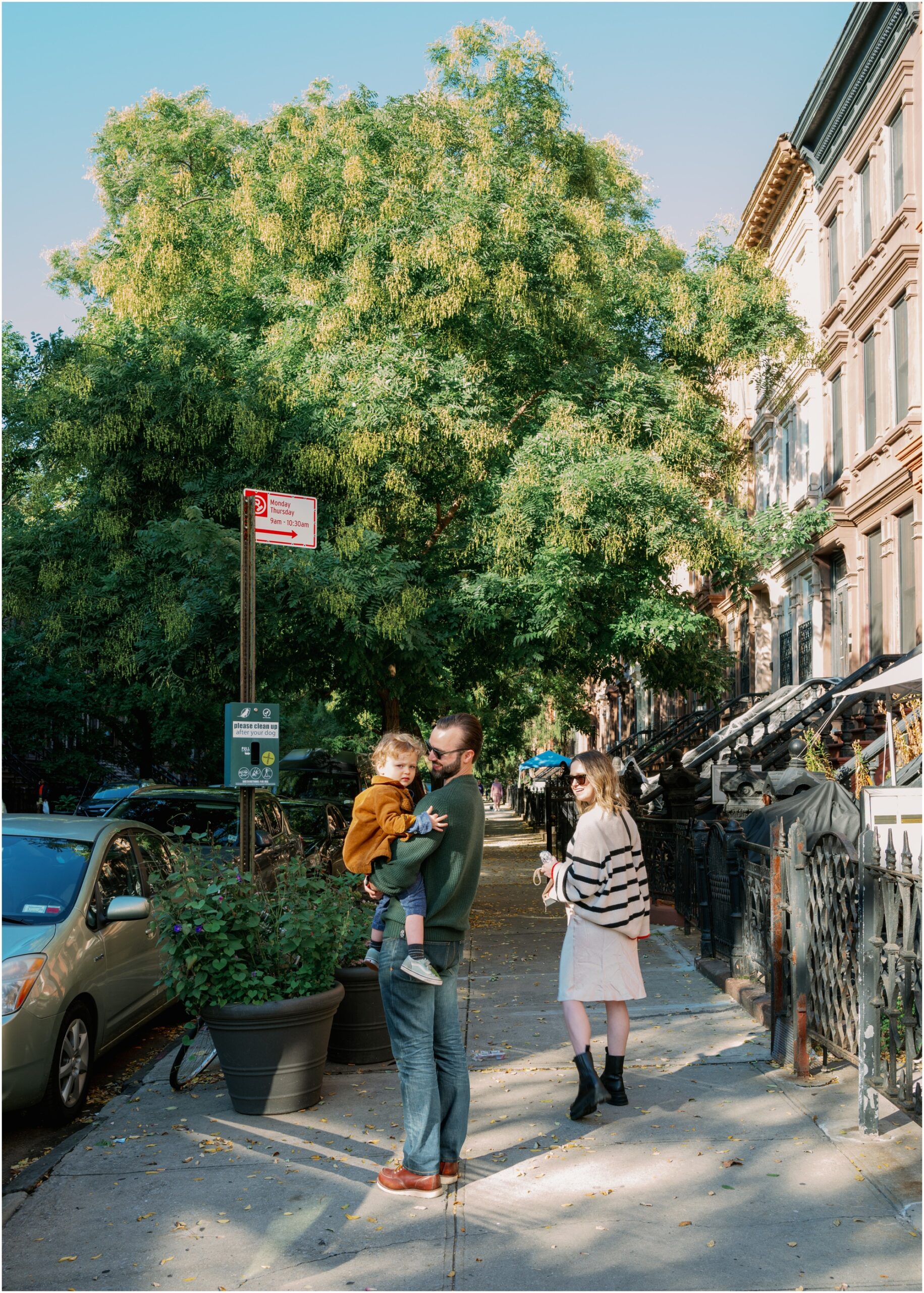 Family walks together on the sidewalk in Brooklyn, New York