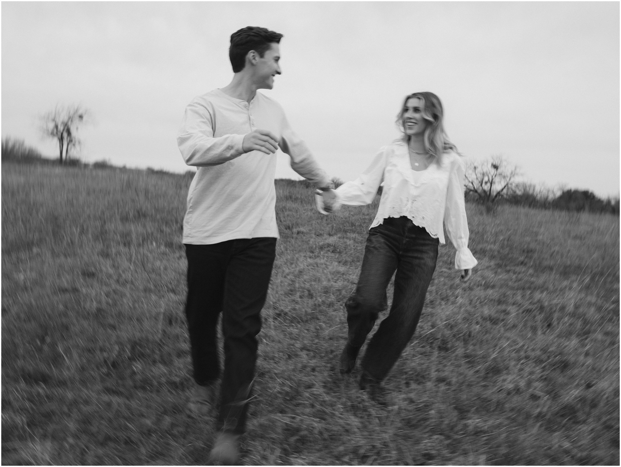 blurry photos on couple walking in field in fort worth texas engagement session