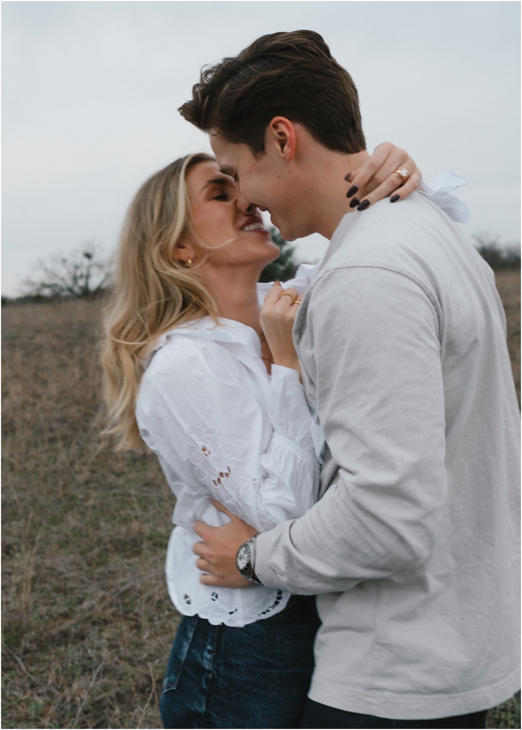 couple kissing in a field in fort worth texas engagement session