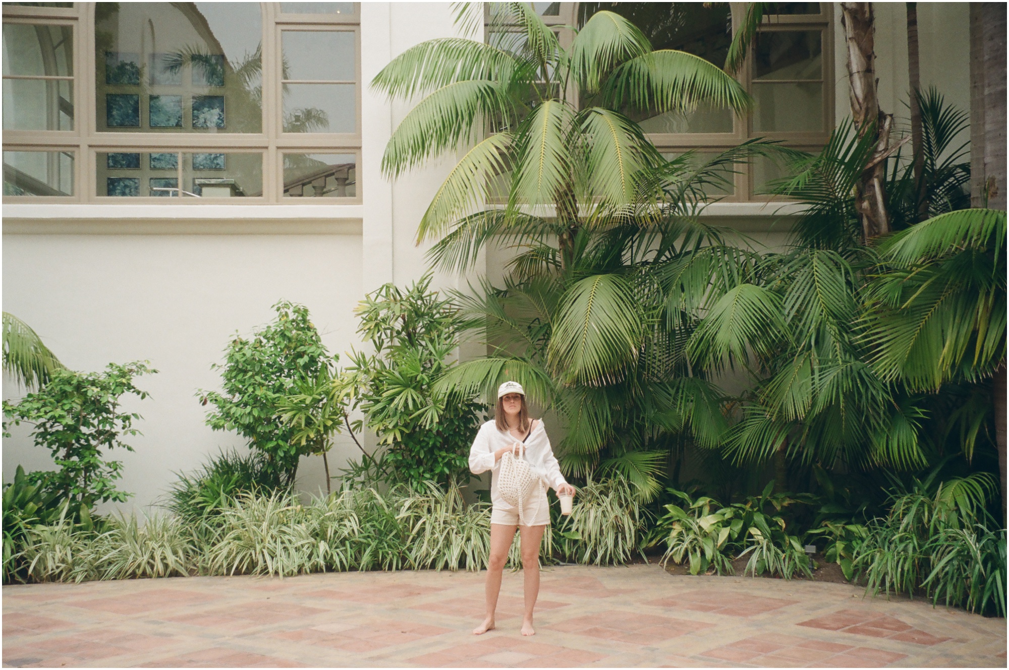 girl in front of palm trees at ritz carlton Laguna Niguel on 120mm film