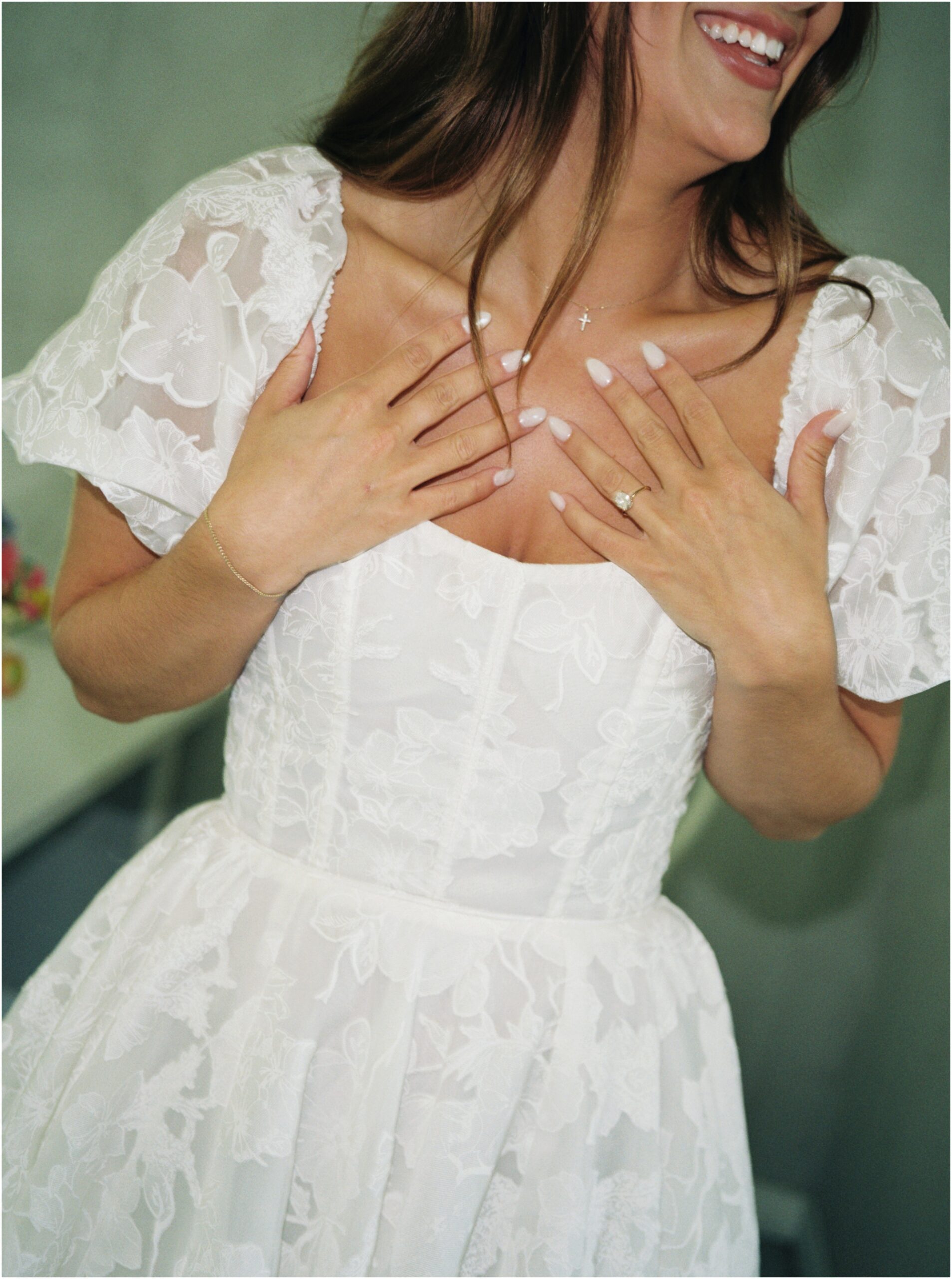 bride on her wedding day showing off nails and ring