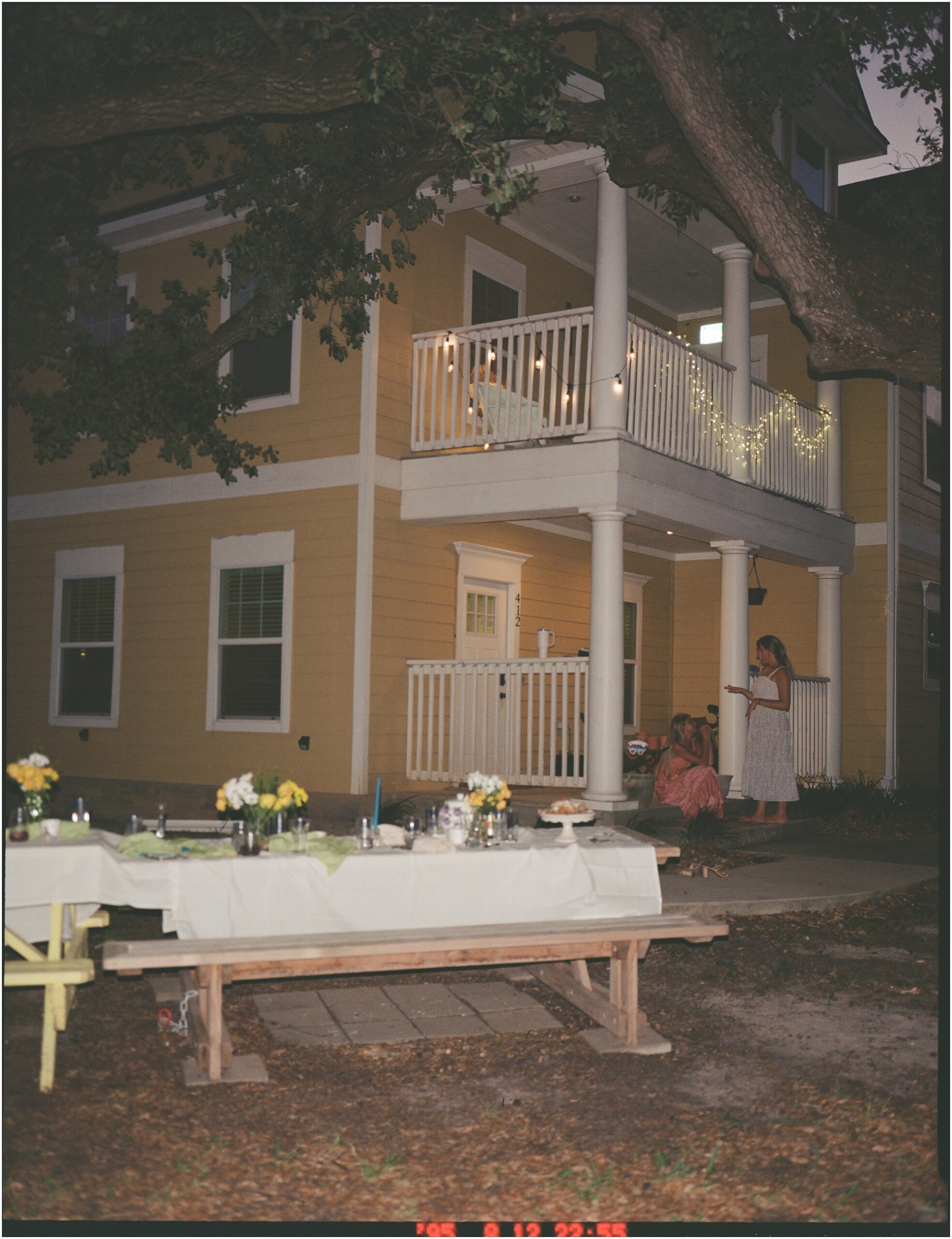 Yellow house with dinner table in front yard set of a birthday dinner on 120mm film