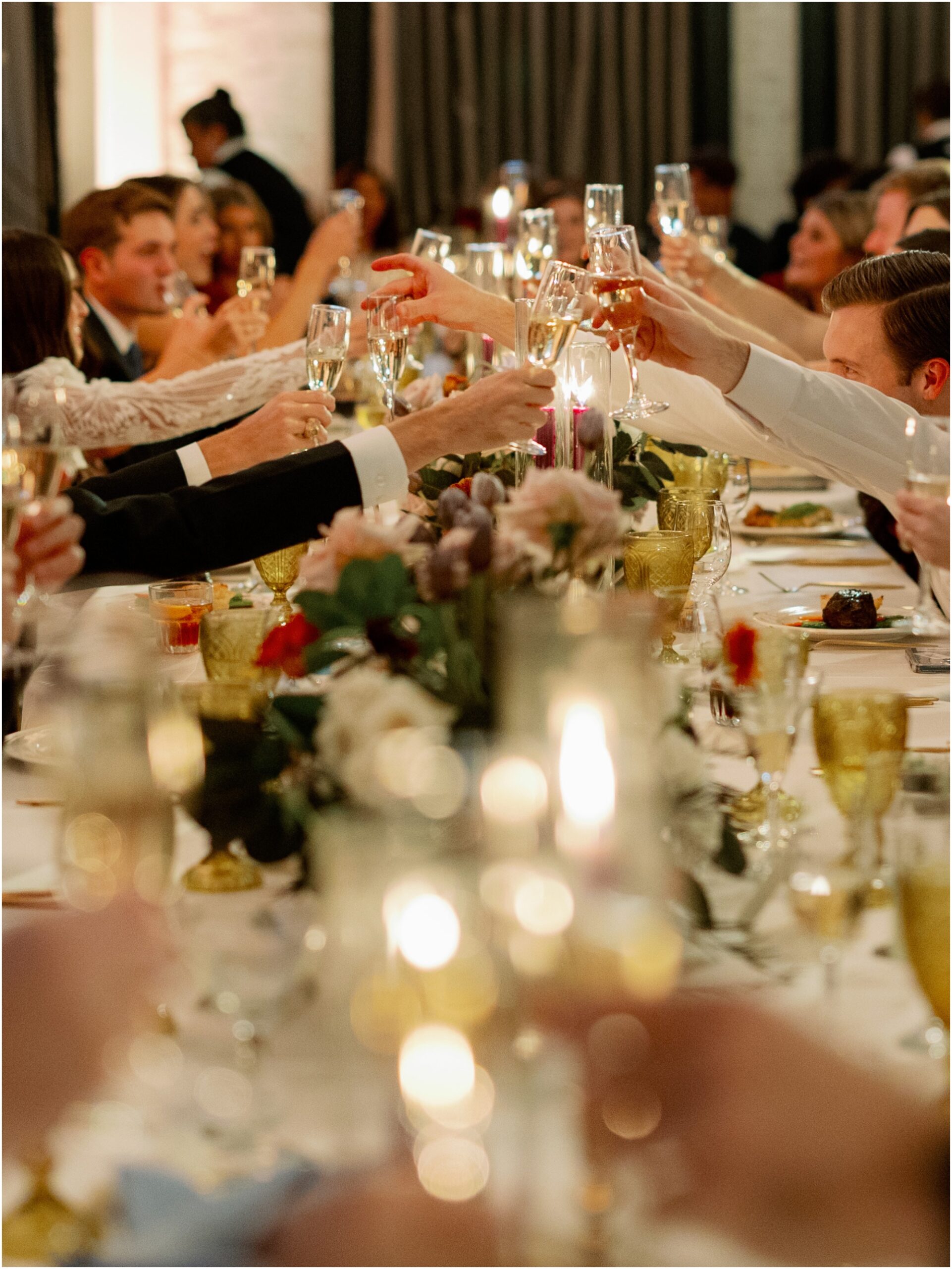 glasses clinking at wedding reception