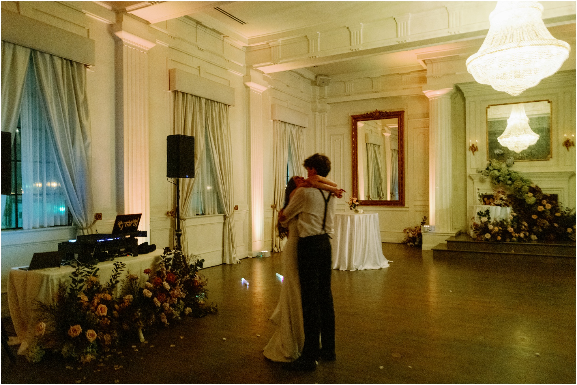 Bride and groom enjoying their last dance at their wedding under ambient light.