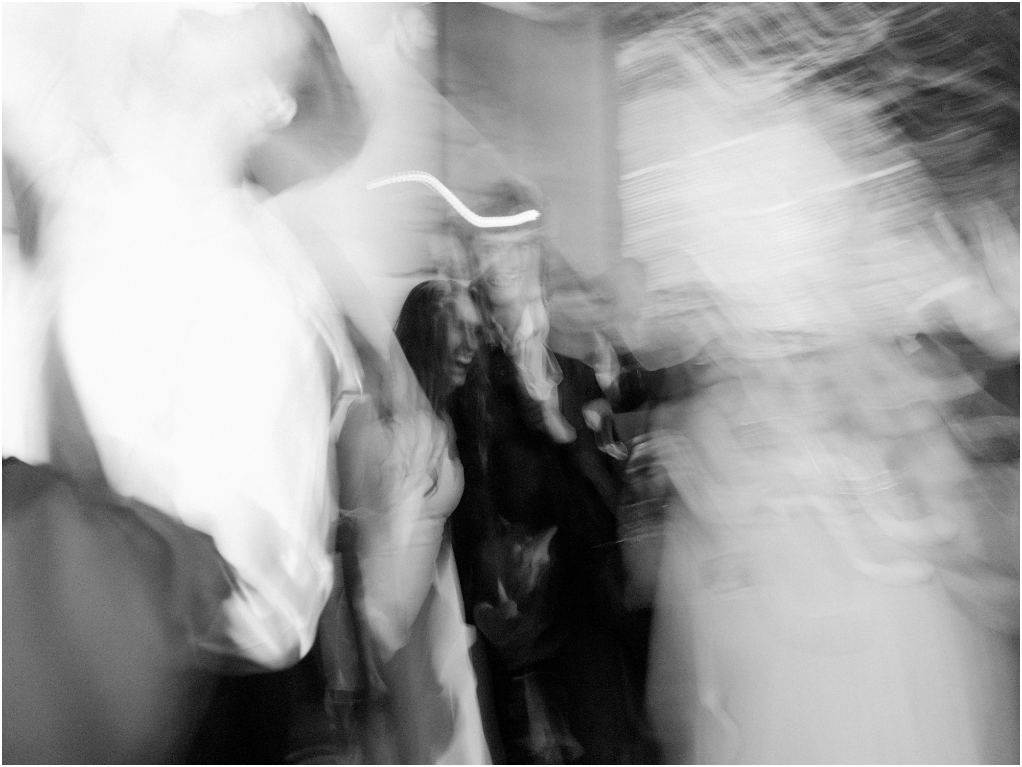 black and white blurry photo of bride and groom exiting wedding